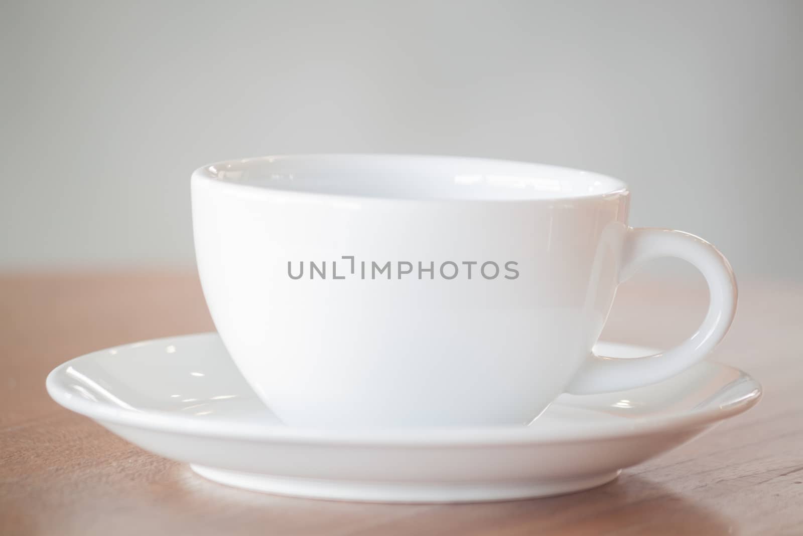 White coffee cup on wooden table, stock photo