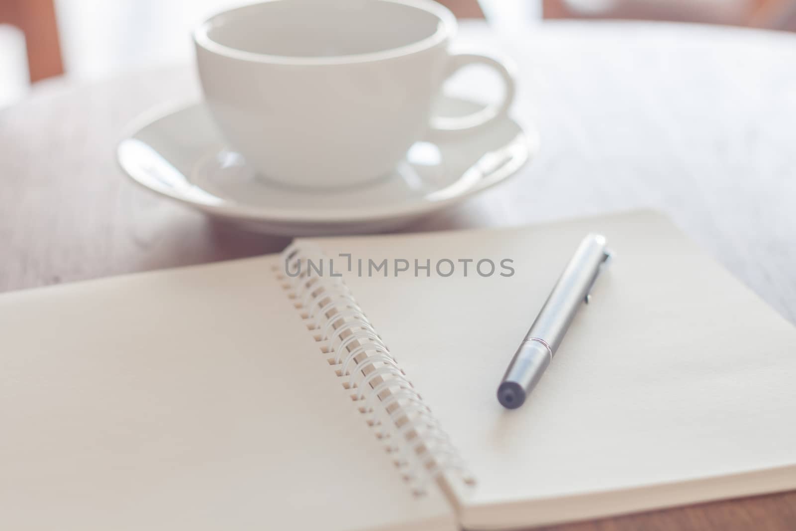 Blank notebook with pen on wooden table, stock photo