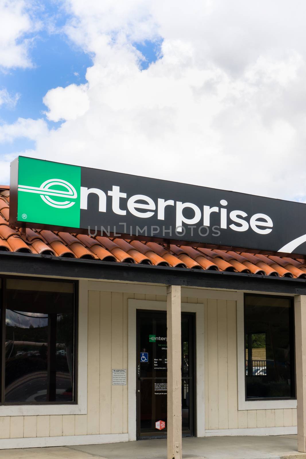 SANTA CLARITA, CA/USA - MARCH 1, 2015: Enterprise car rental front and sign vertical image. Enterprise Rent-A-Car is a car rental company headquartered in the United States.