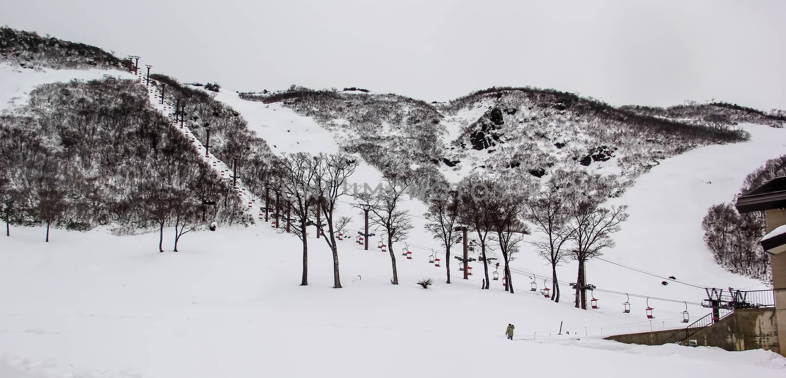 Ski chair lift with skiers on mountain