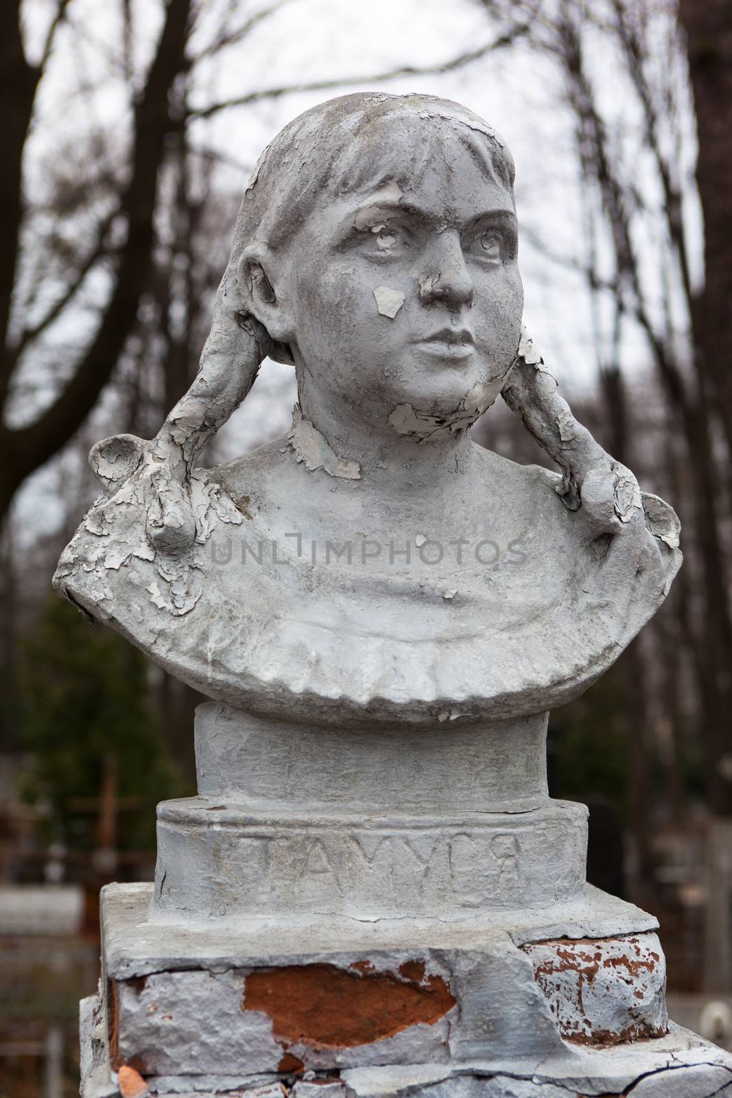 Old cemetery sculpture of the young girl.