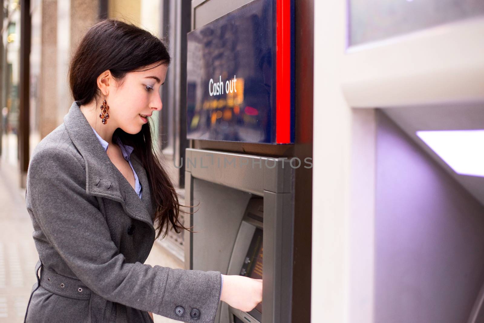 young woman withdrawing cash at the atm.