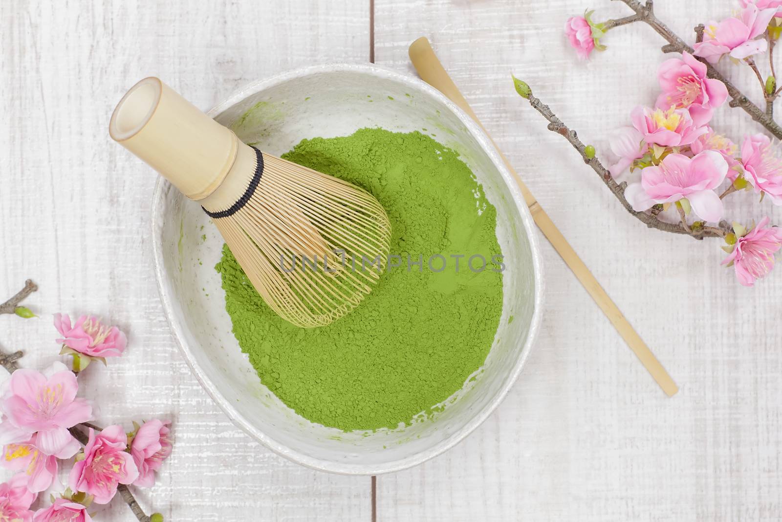 Still life with green matcha tea powder and bamboo whisk. Japanese Tea Ceremony: Preparation of matcha powdered green tea