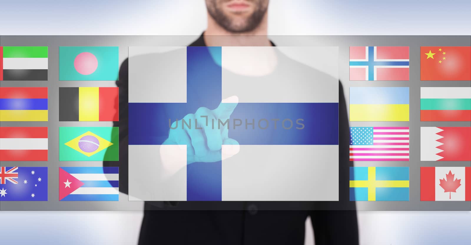 Hand pushing on a touch screen interface, choosing language or country, Finland