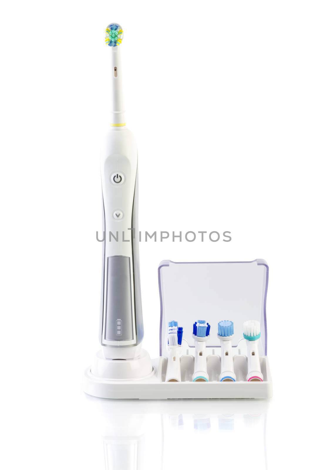 White Electric Toothbrush with stand charger on white by manaemedia