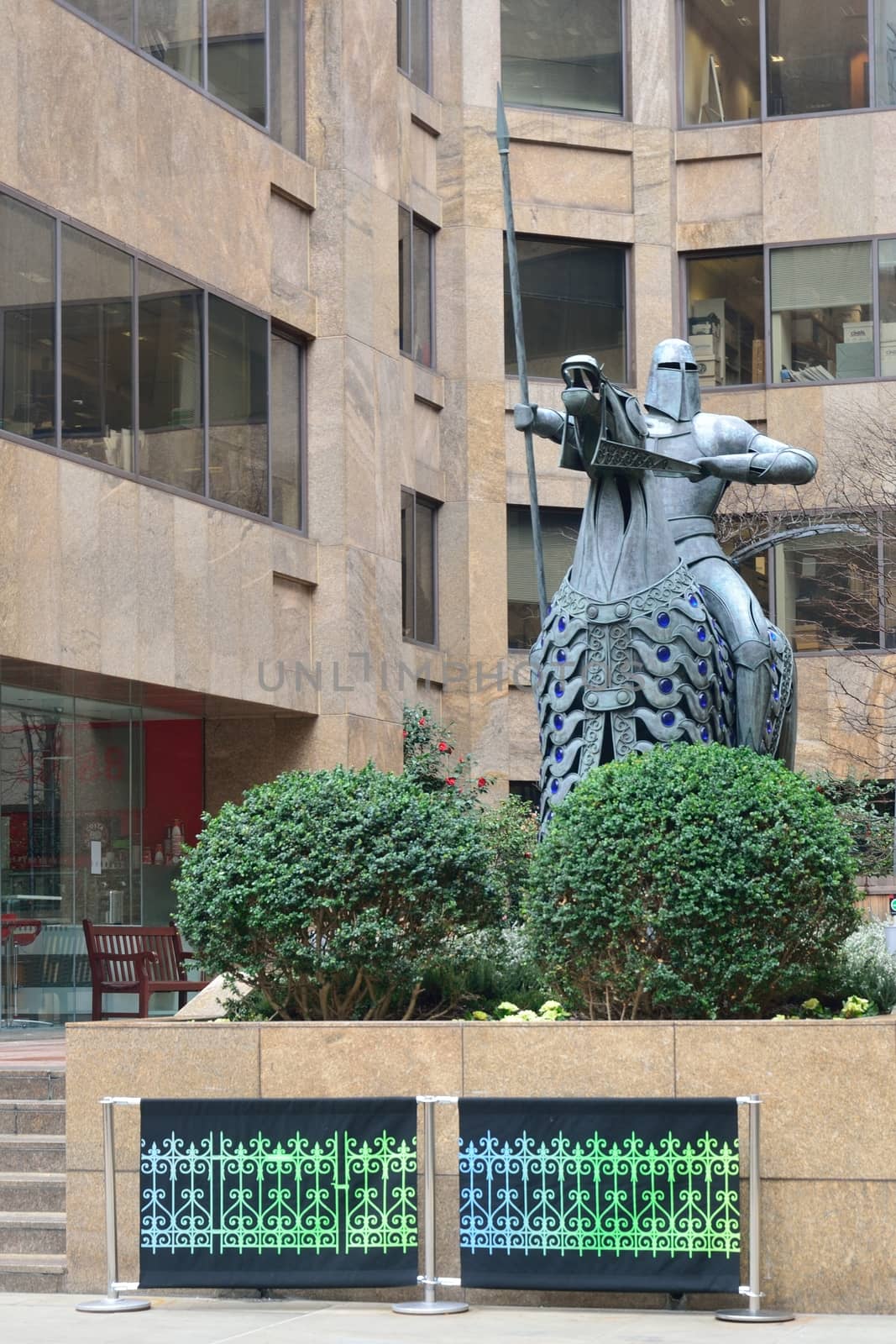 Modern statue of knight by new building