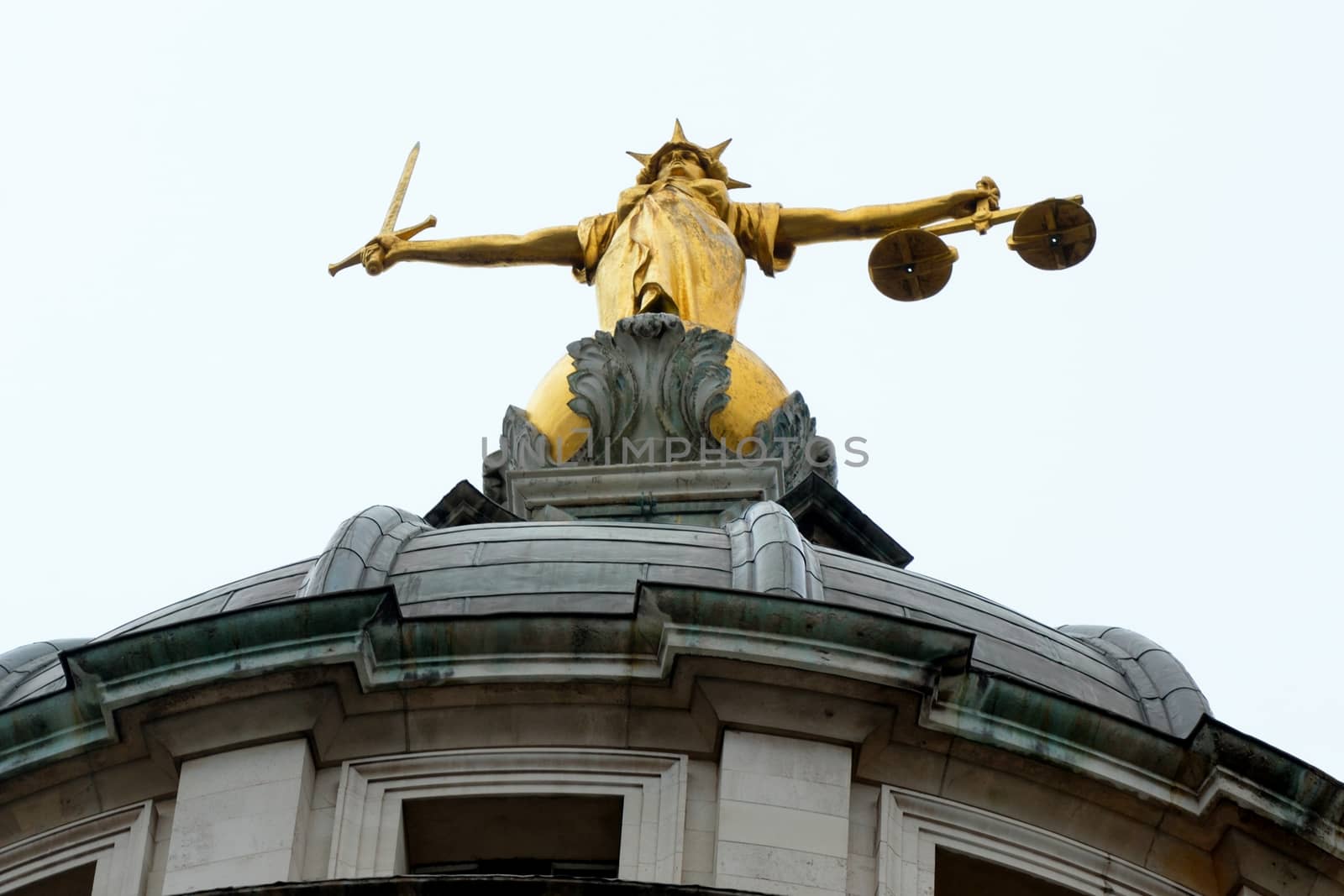 Looking up at justice statue old bailey