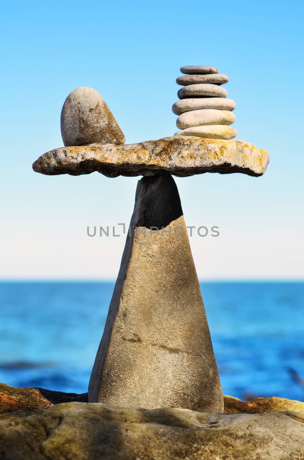 Balance of pebbles on the top of triangle stone