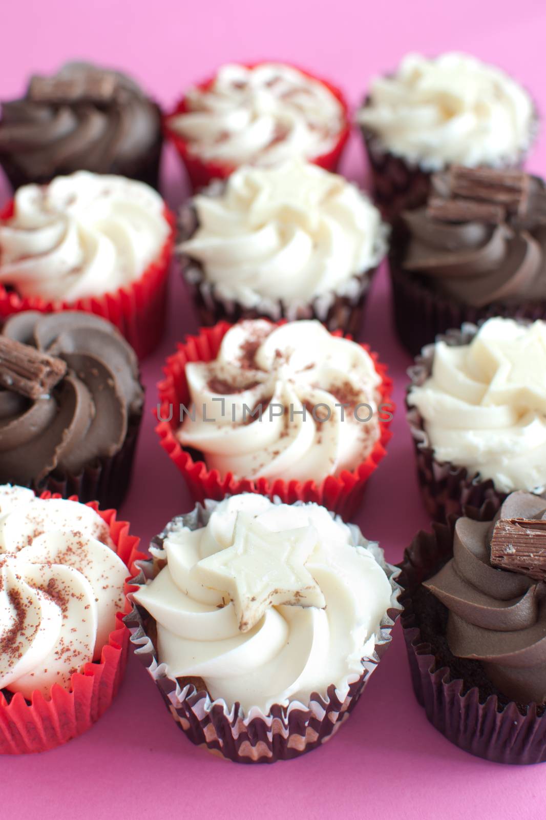 Array of cupcakes with chocolate and cream