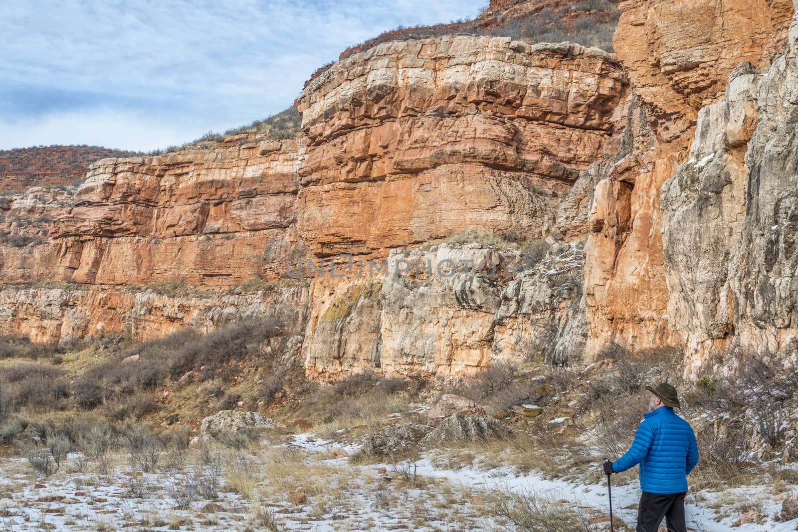 hiker in sandstone canyon by PixelsAway