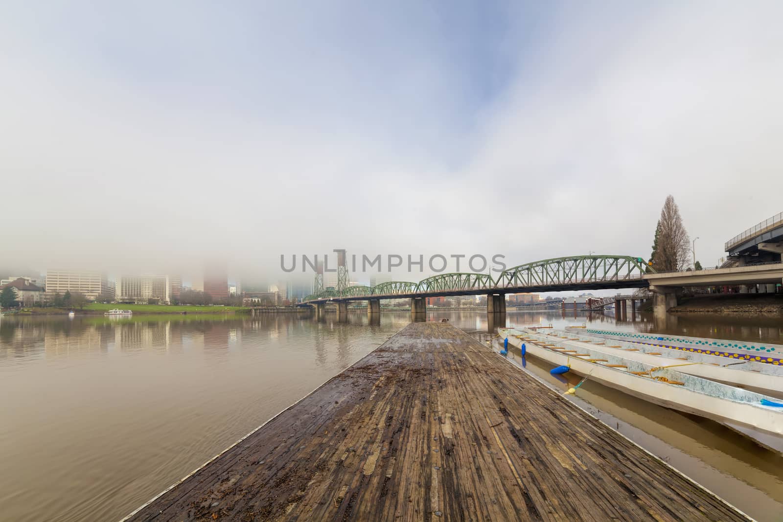 Floating Boat Dock on Willamette River with Portland Oregon Skyline and Hawthorne Bridge on Foggy Morning