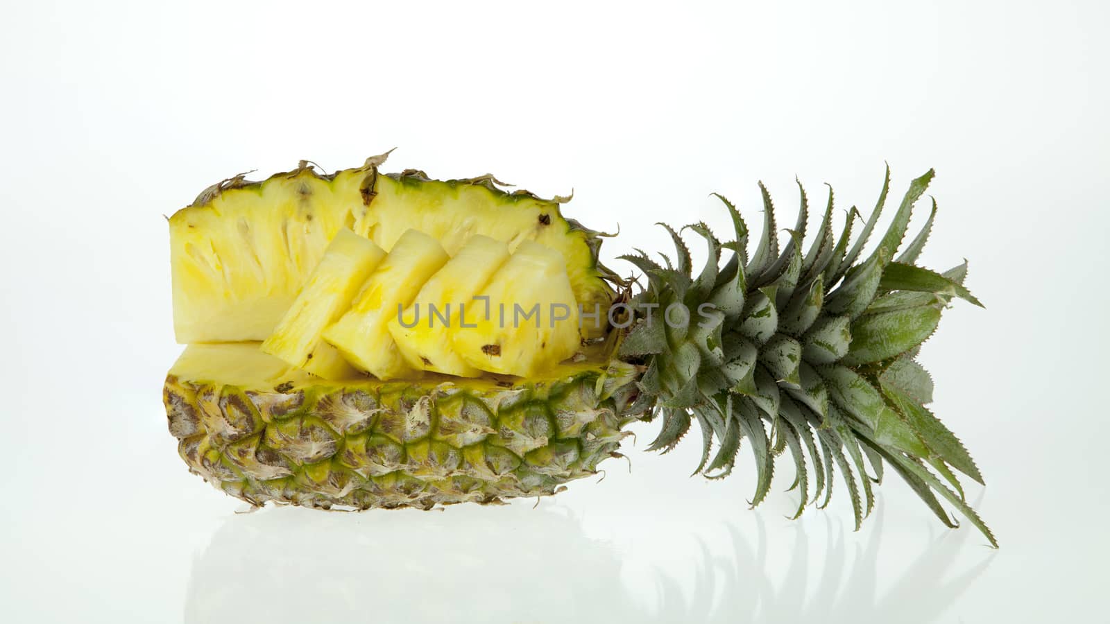 pineapple with slices isolated on white by Chattranusorn09