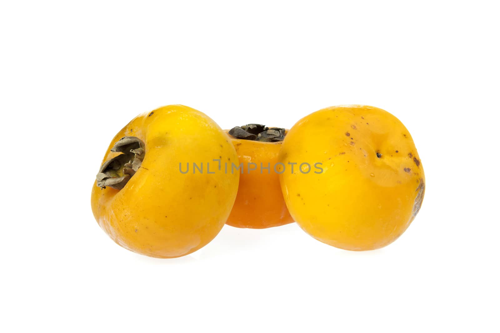 Three fresh Persimmons on a white background