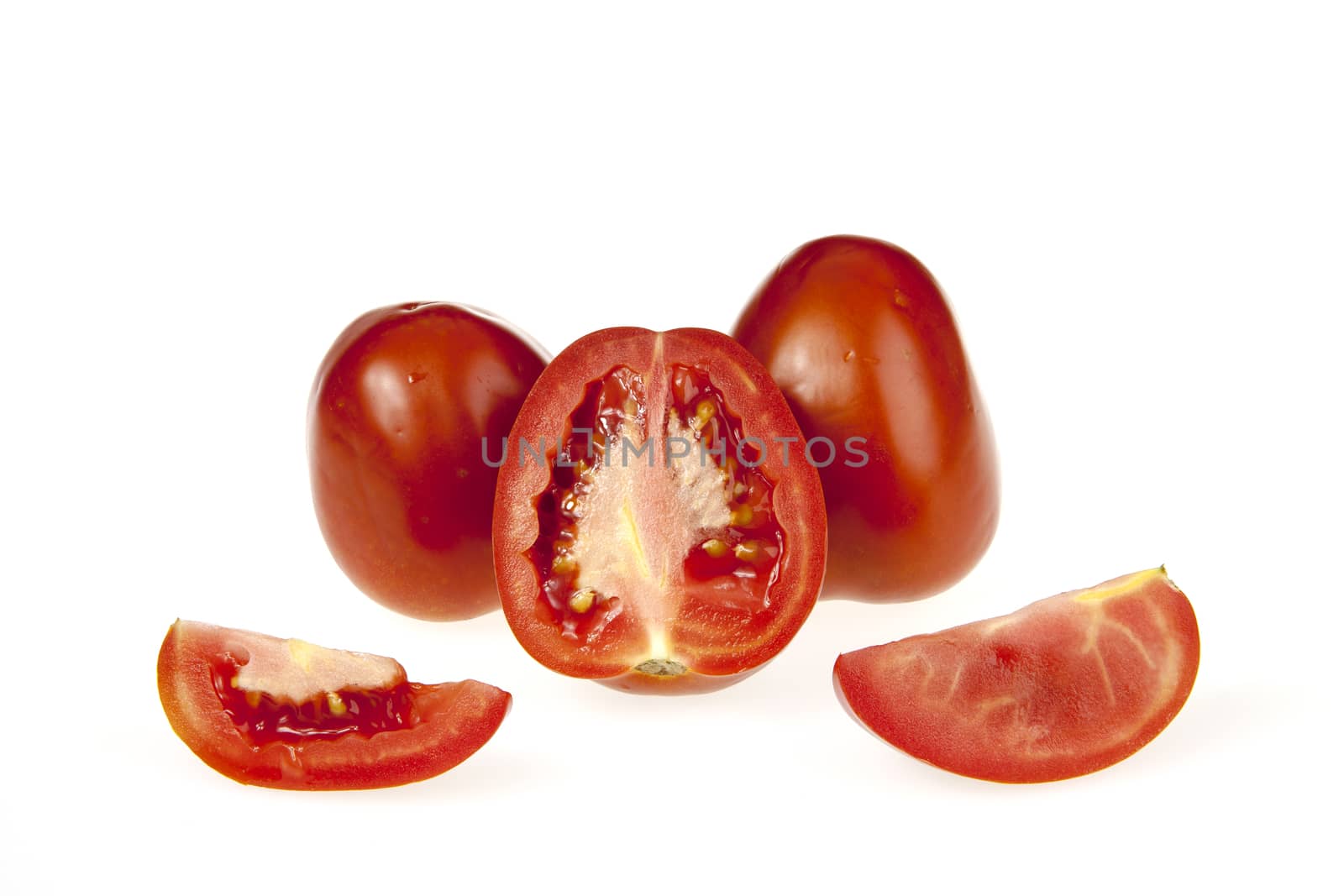 Tomatoes and a slice  isolated on white background
