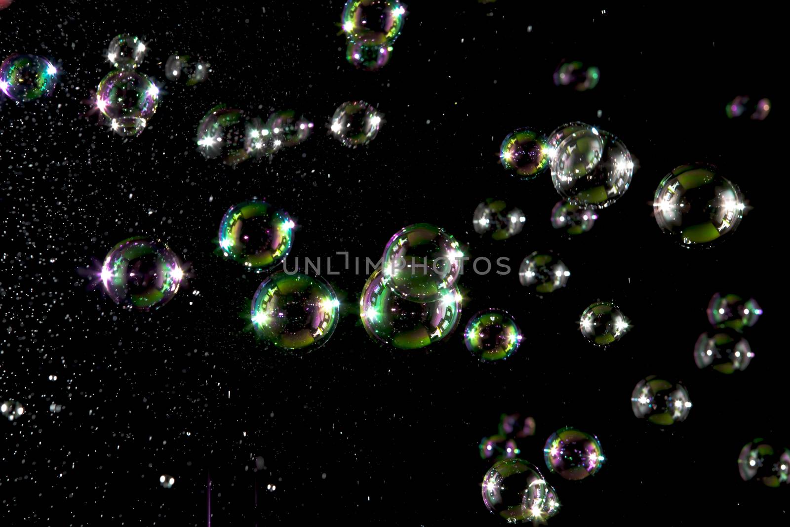 Soap bubbles with light  on black blackground