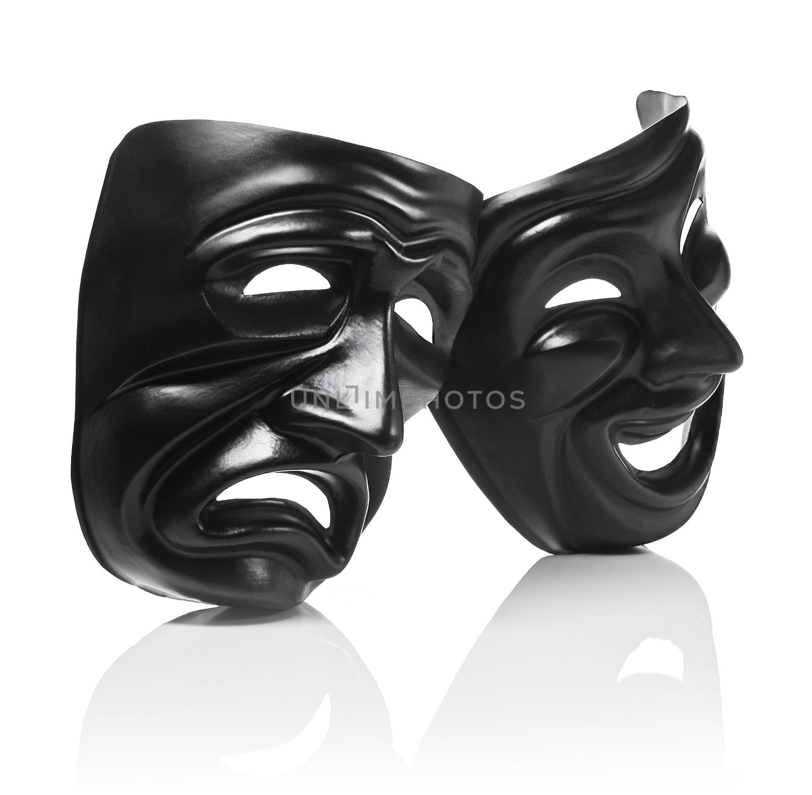 Generic plastic masks as theatrical symbols isolated on white with reflection