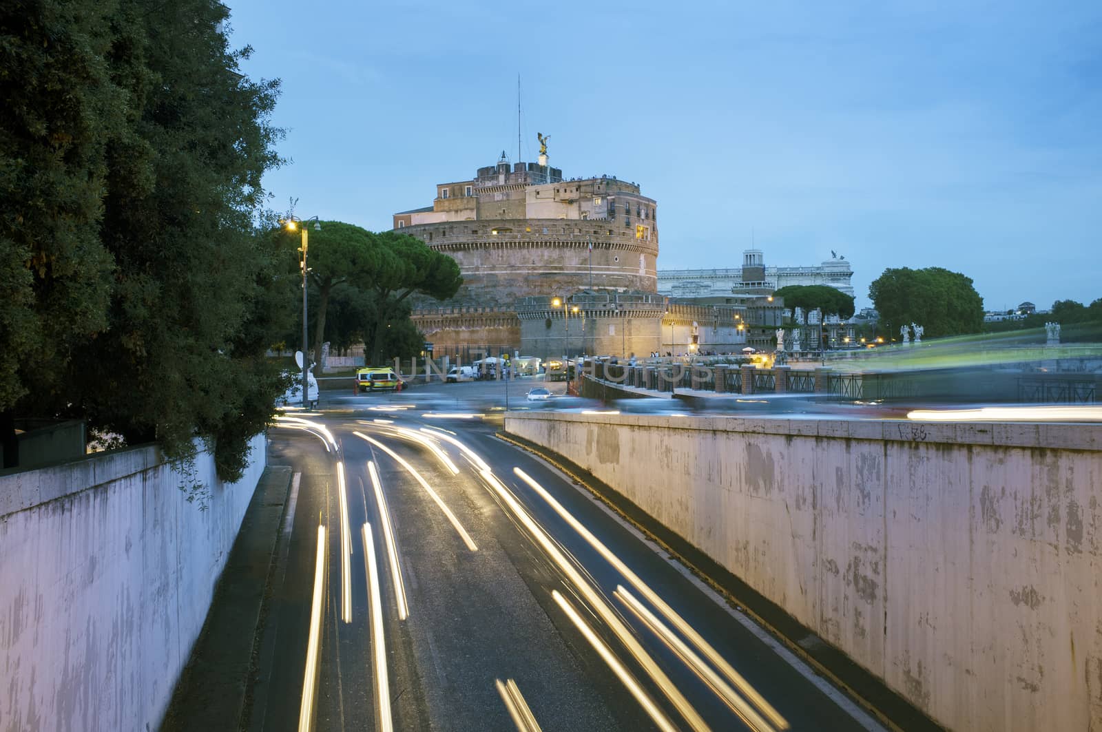 The Mausoleum of Hadrian, usually known as Castel Sant'Angelo in evening light. Light streaks from moving vehicles. Rome, Italy