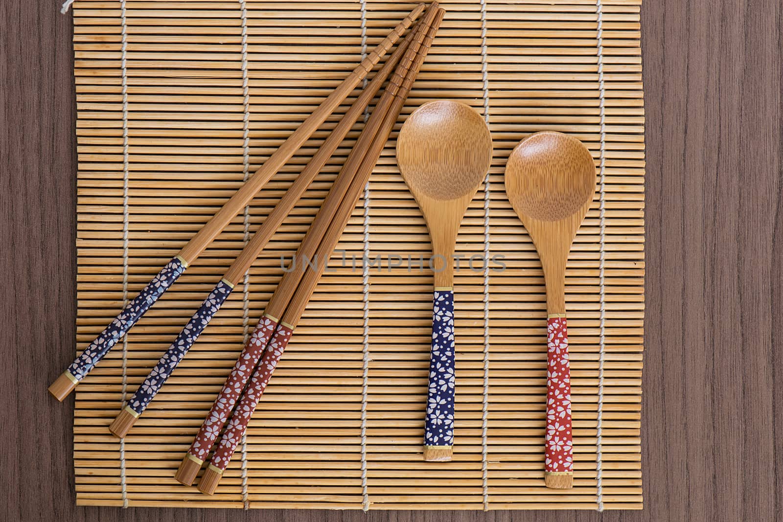 Bamboo sushi tools over a bamboo mat by dalomo84