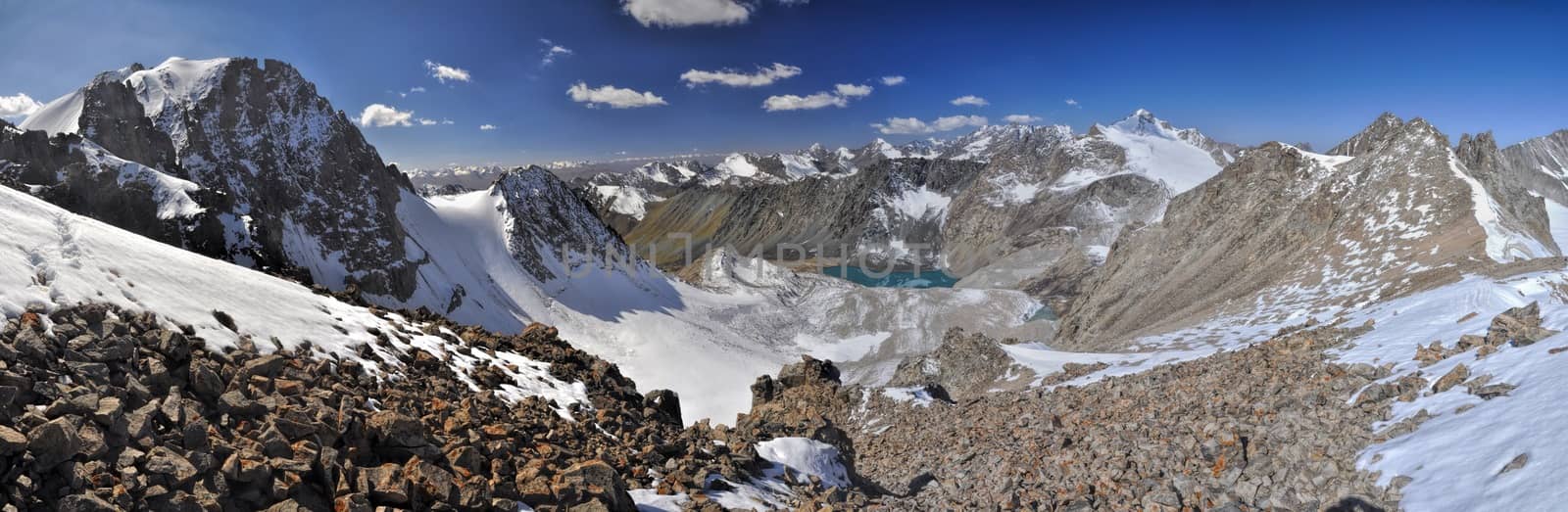 Scenic panorama of lake below highest mountain peaks in Ala Archa national park in Tian Shan mountain range in Kyrgyzstan