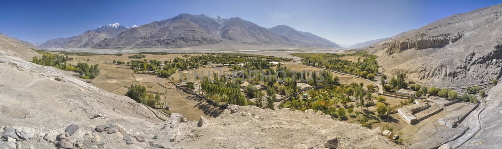 Scenic panorama of green valley on arid landscape in Tajikistan on sunny day
