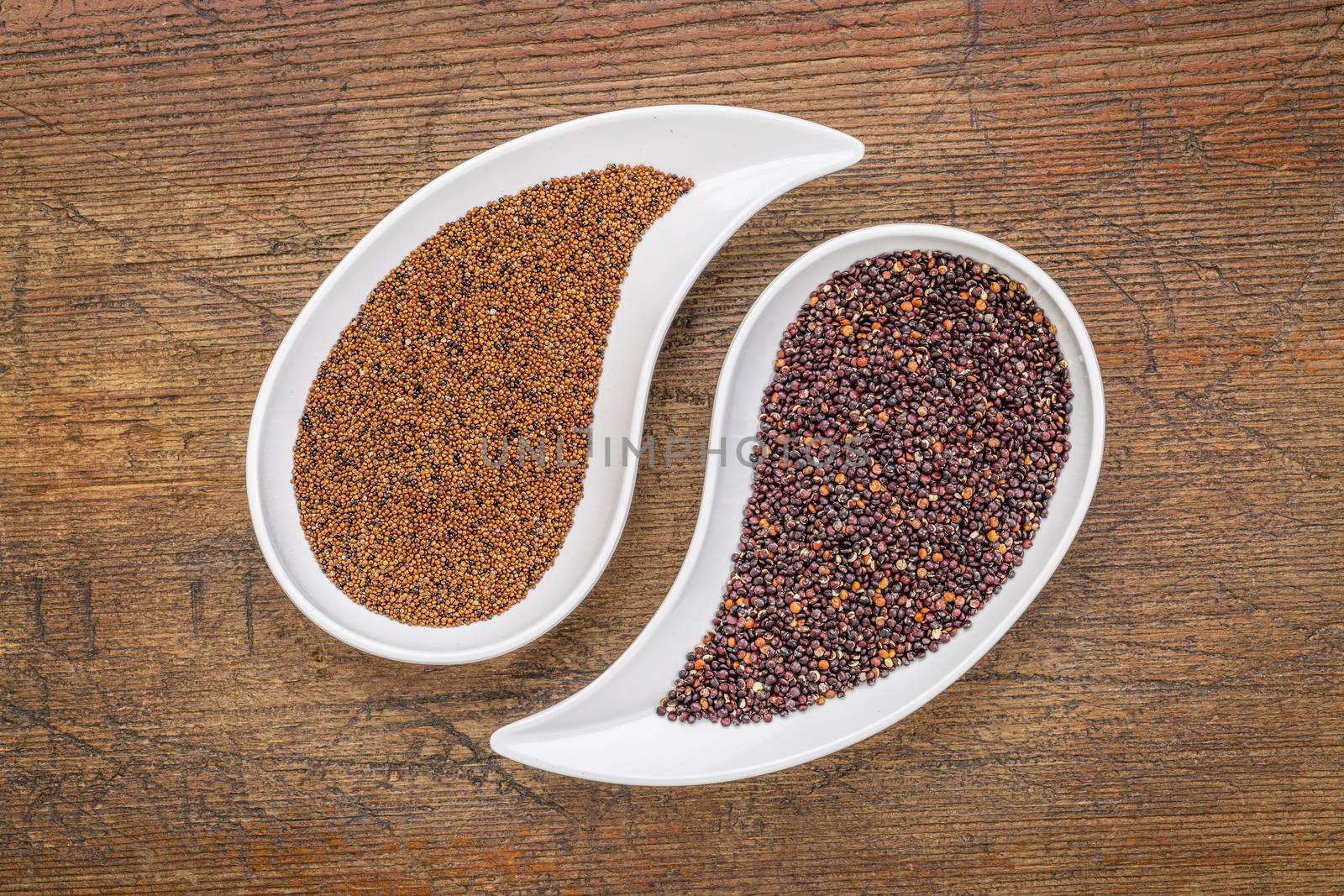 kaniwa and black quinoa  grain on on teardrop shaped bowls against rustic wood