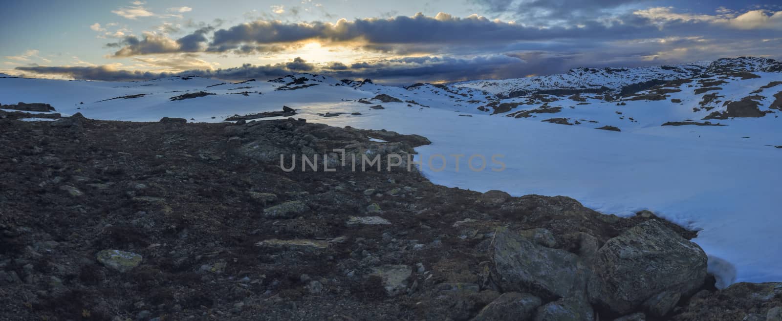 Scenic evening panorama of snowy landscape near Trolltunga in Norway