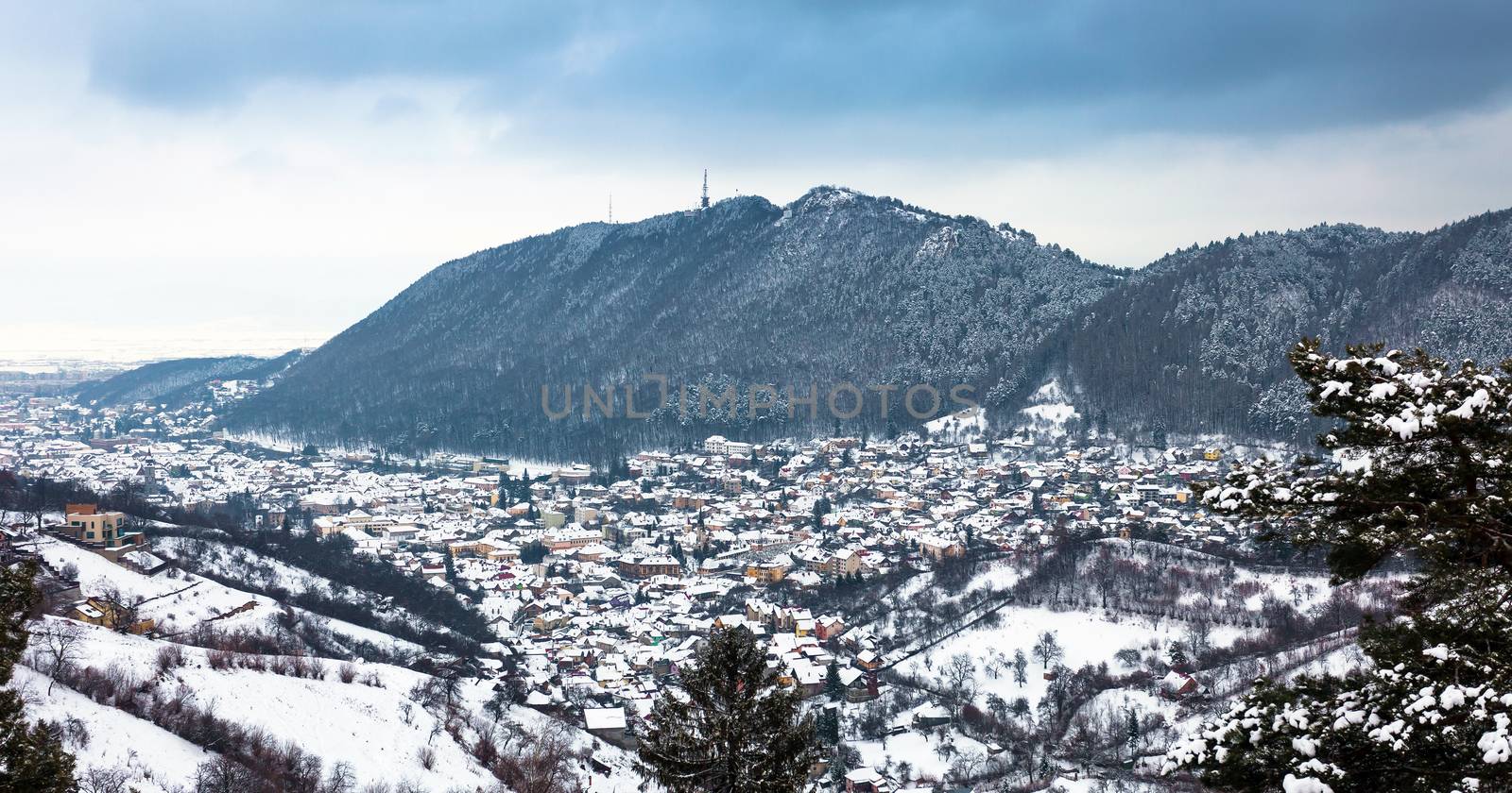 Brasov City panoramic view on winter season with Tama mountain on background, Romania