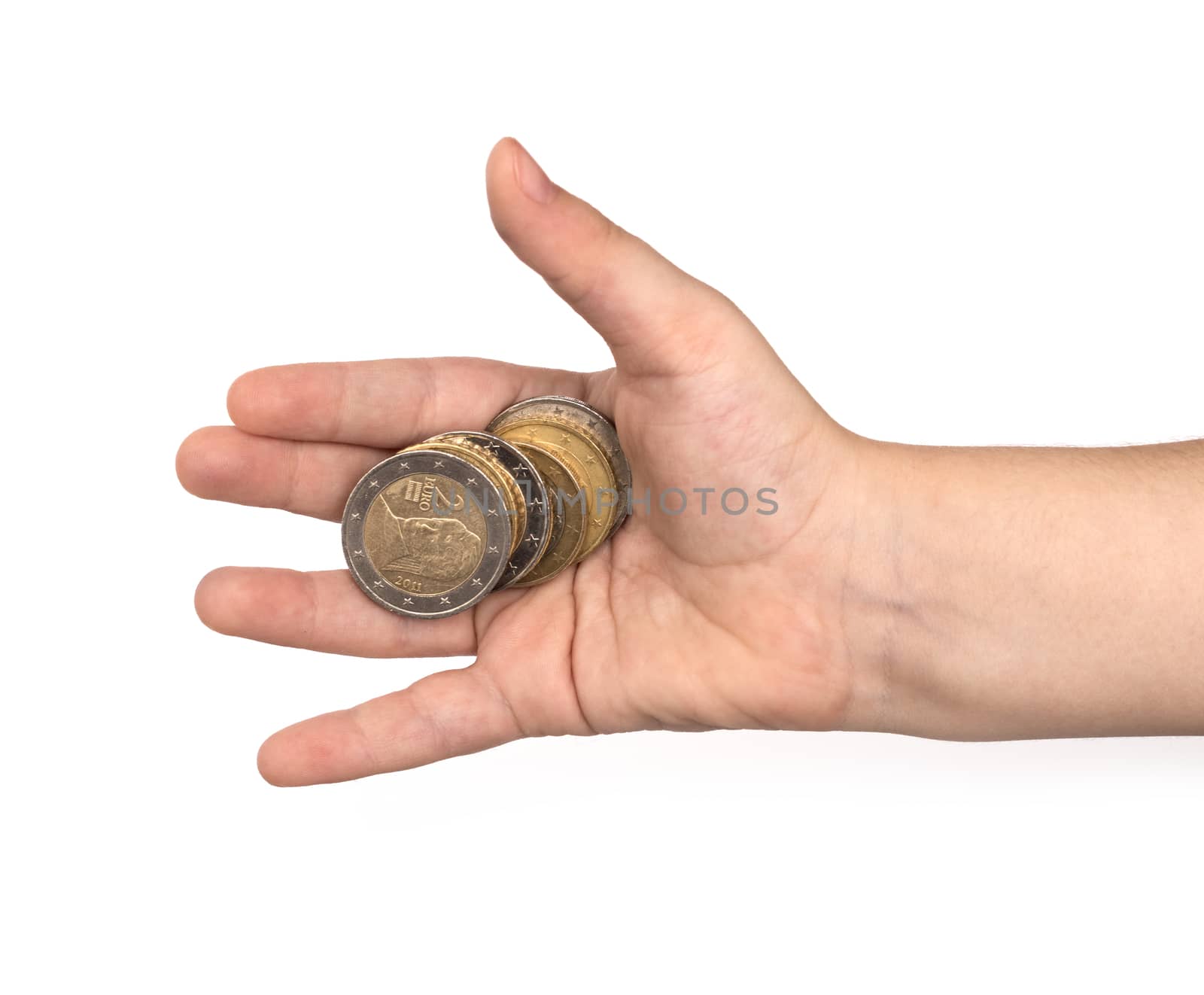 Coins in child's hand on white background