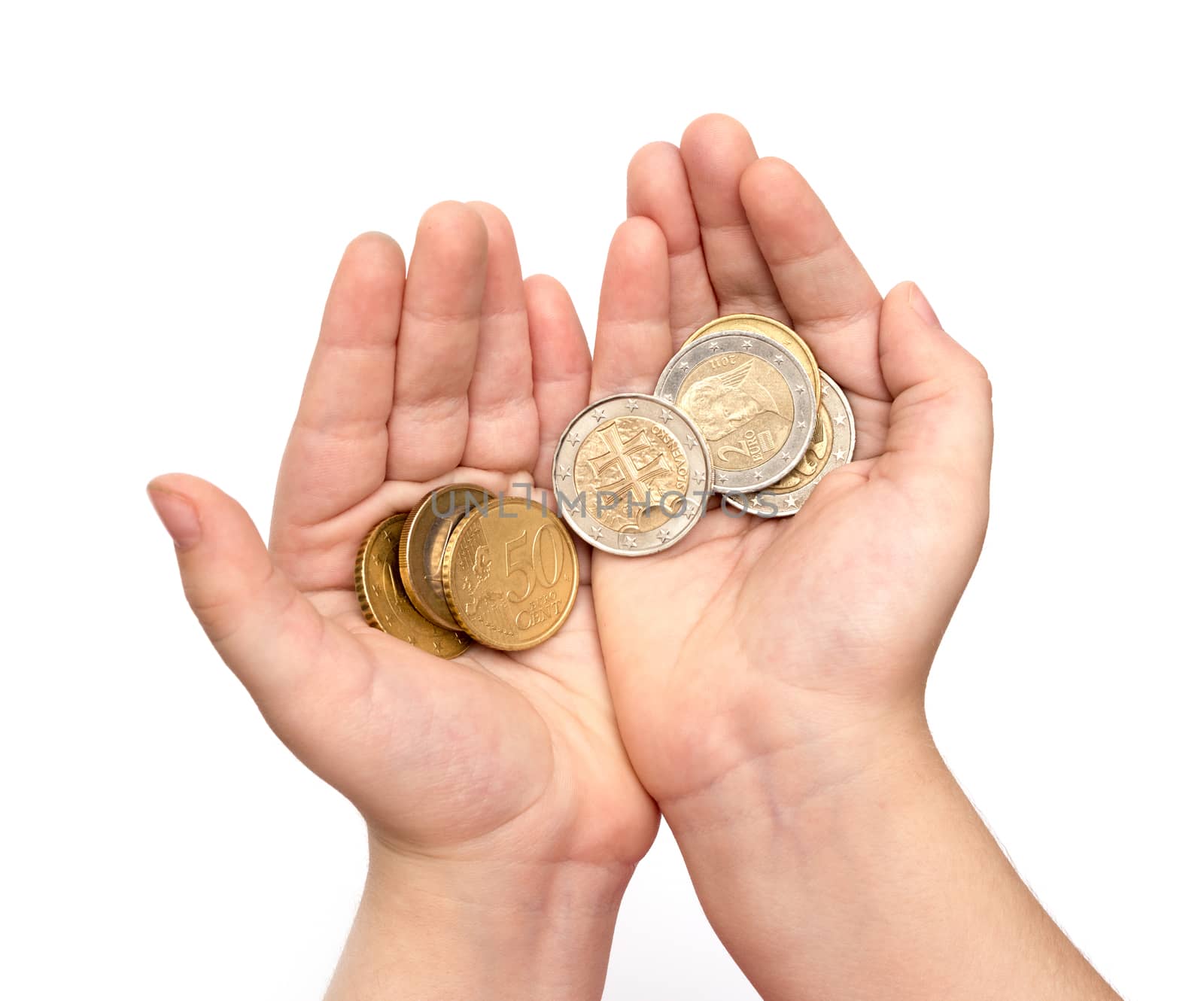 Coins in child's hand on white background