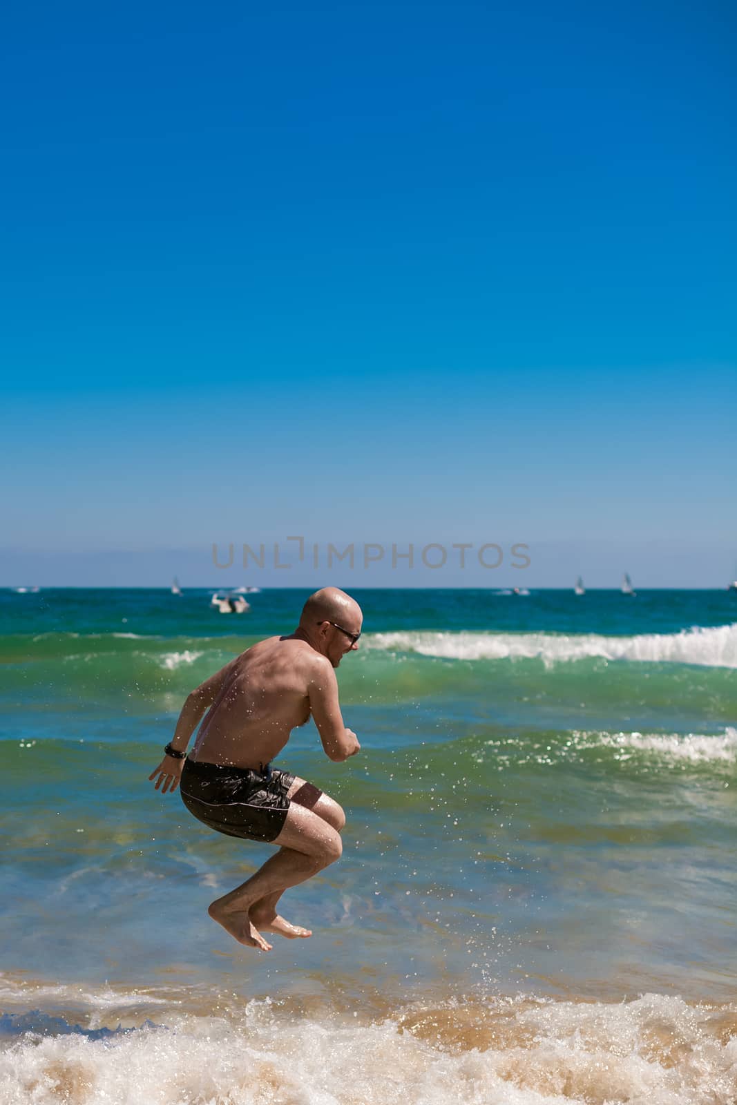 young man on the beach by sarymsakov