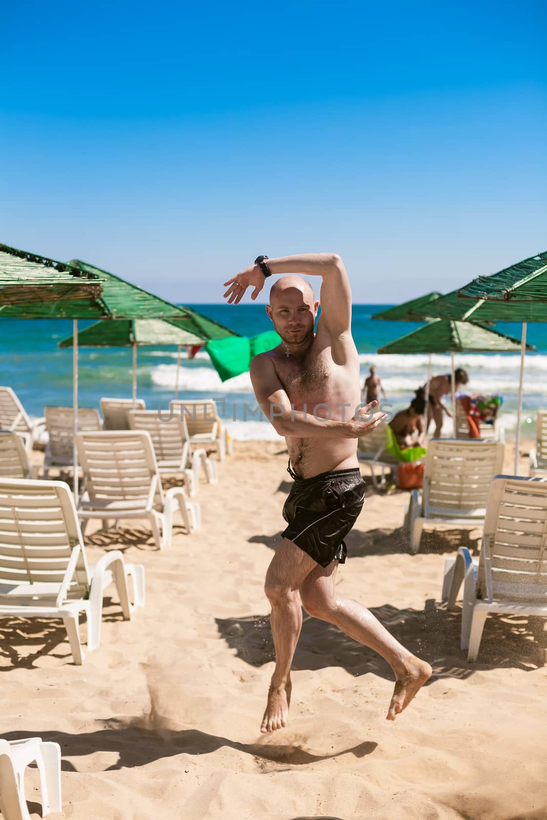 young man on the beach by sarymsakov