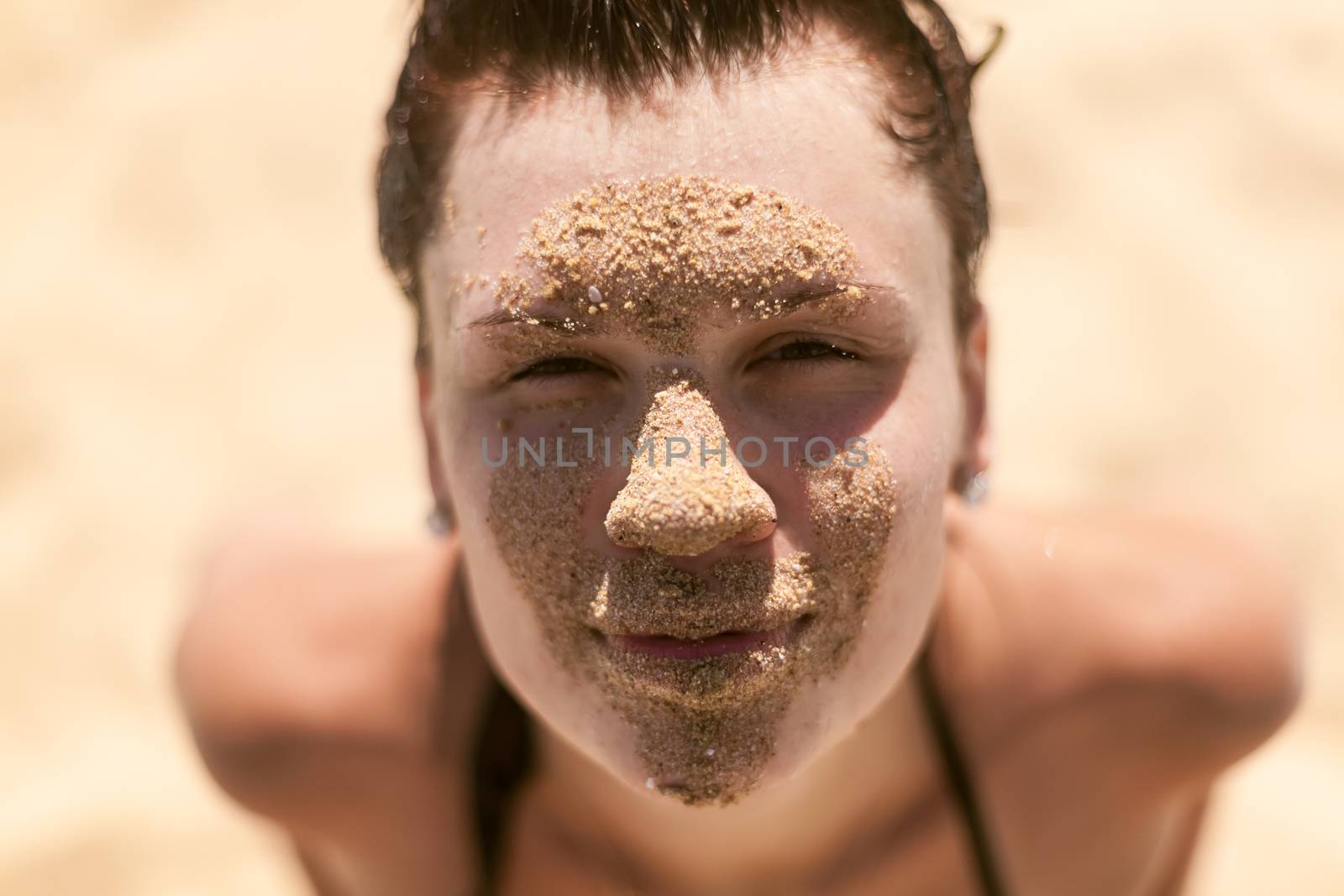 Beautiful girl with sand on face by sarymsakov