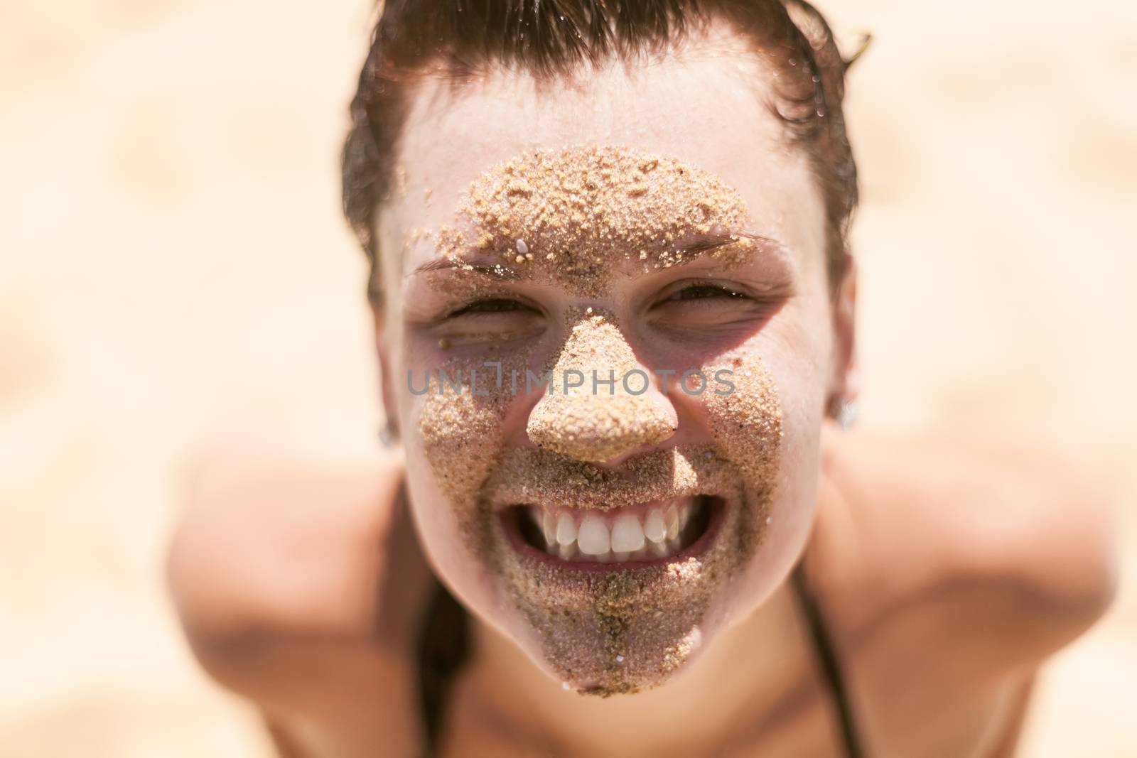 Beautiful girl with sand on face by sarymsakov