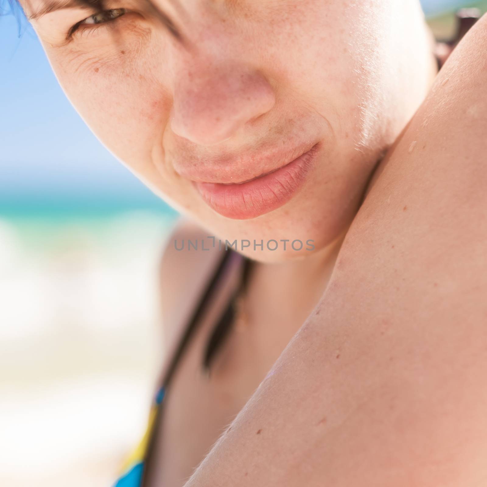 Sexy young woman sunbathing on the beach