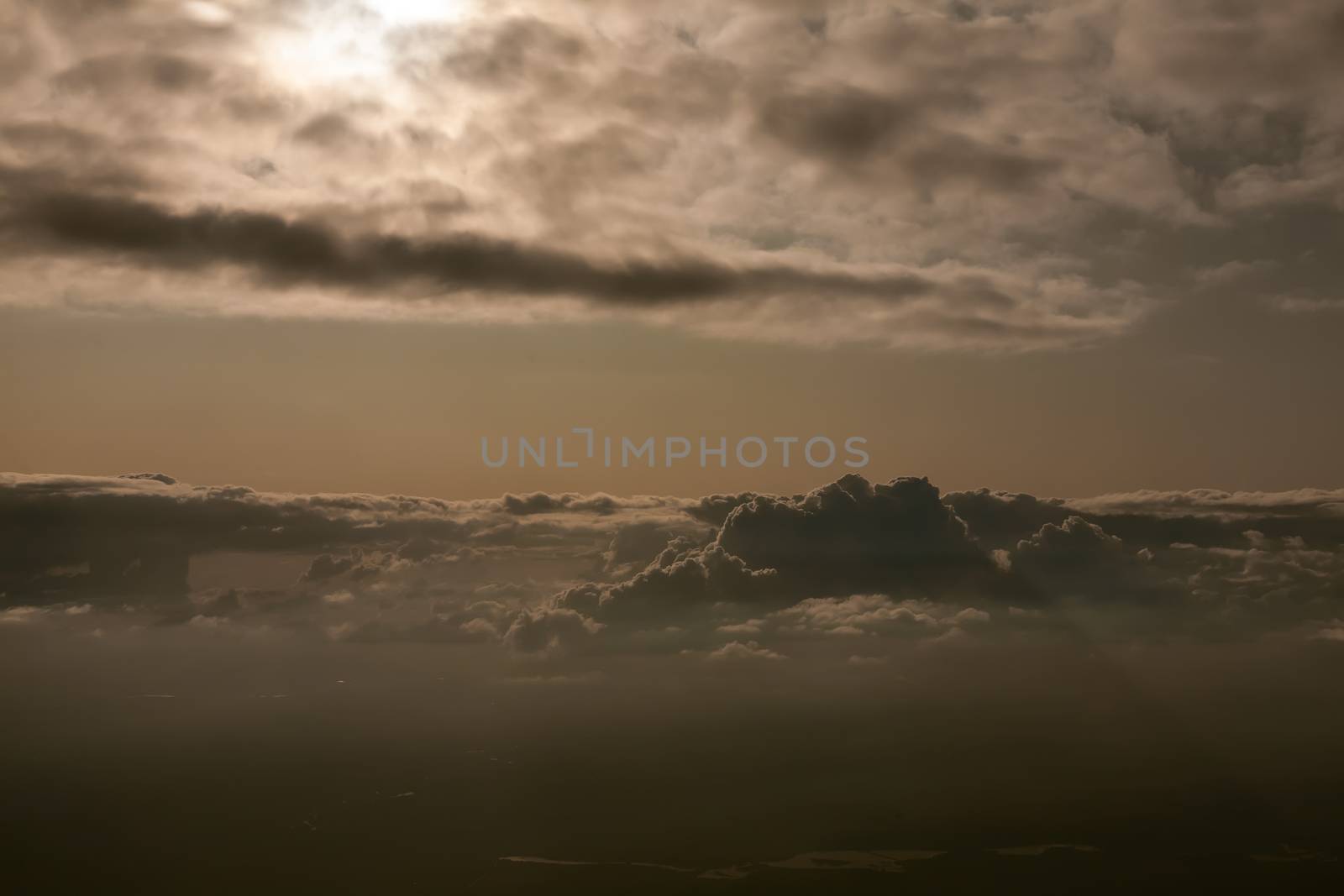 Amazing view from plane on the sky, sunset sun and clouds