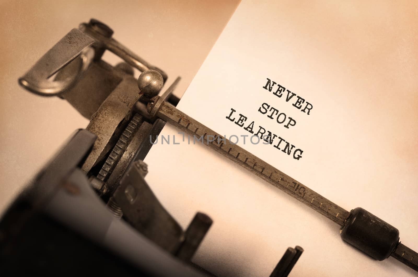 Vintage inscription made by old typewriter, Never stop learning