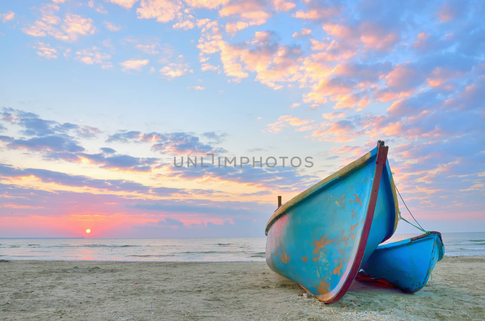 Boat on beautiful beach in sunrise on Black Sea