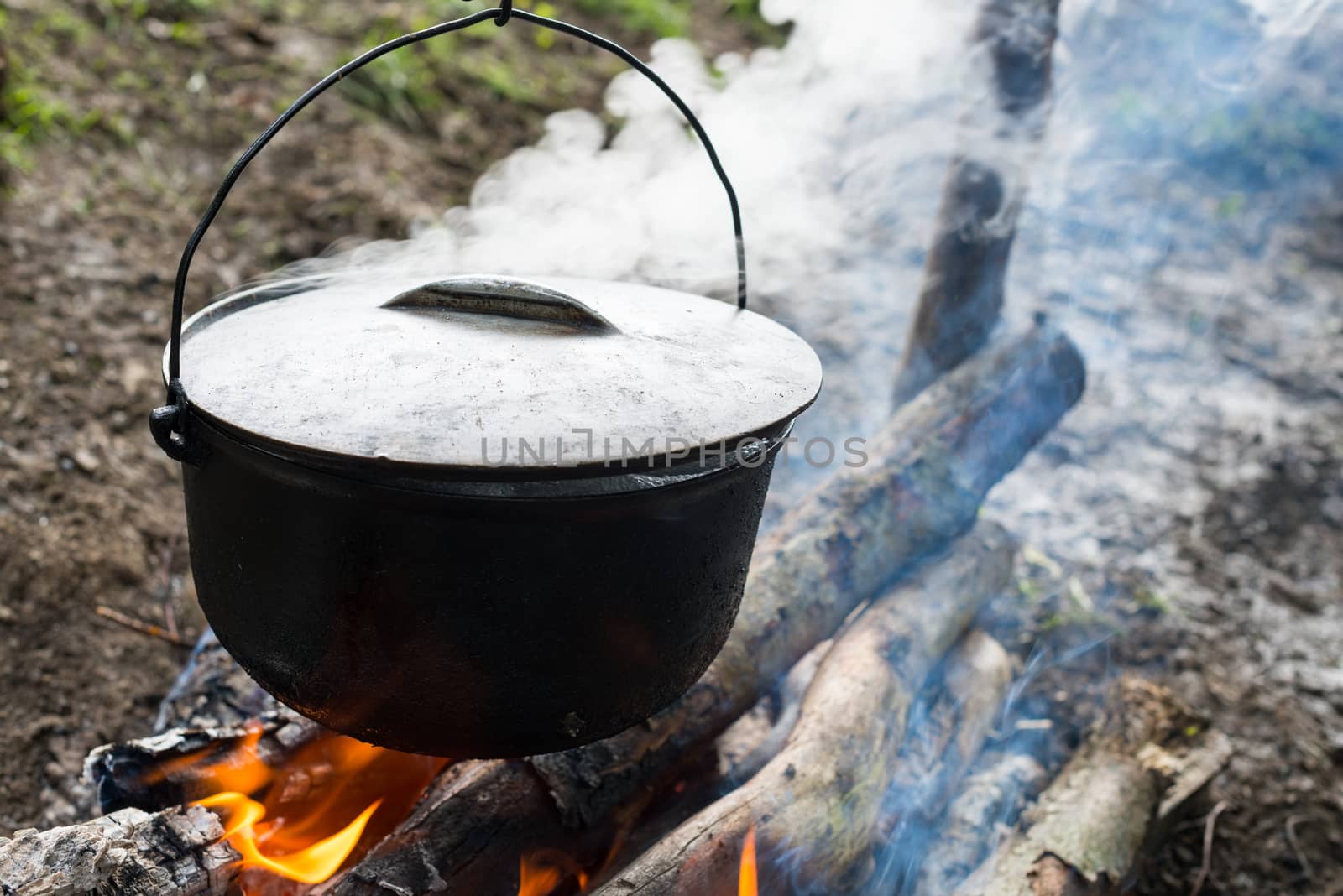 Cauldron on the open fire by rootstocks