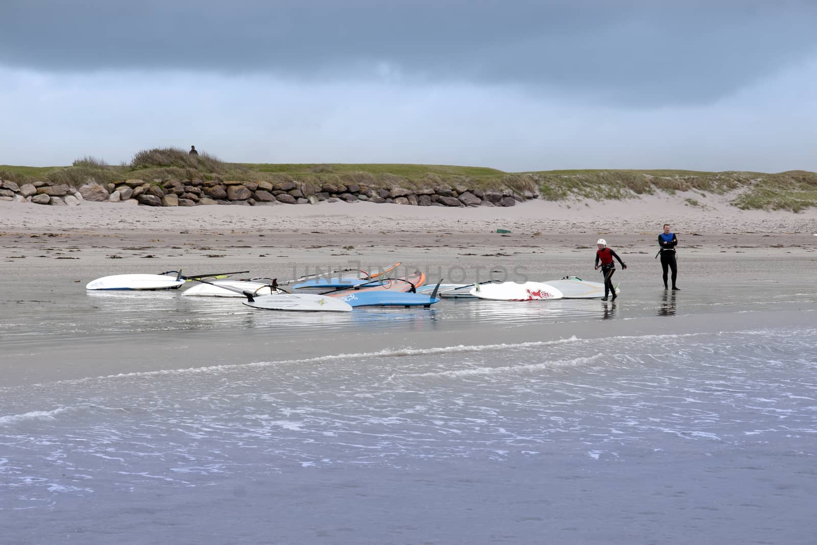 two windsurfers finishing up after race and surf by morrbyte