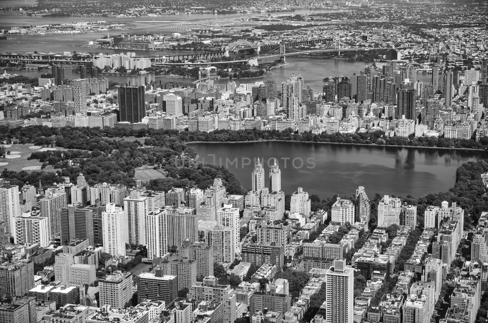 Awesome helicopter view of Jacqueline Kennedy Onassis Reservoir and Central Park with surrounding Skyscrapers - NYC.