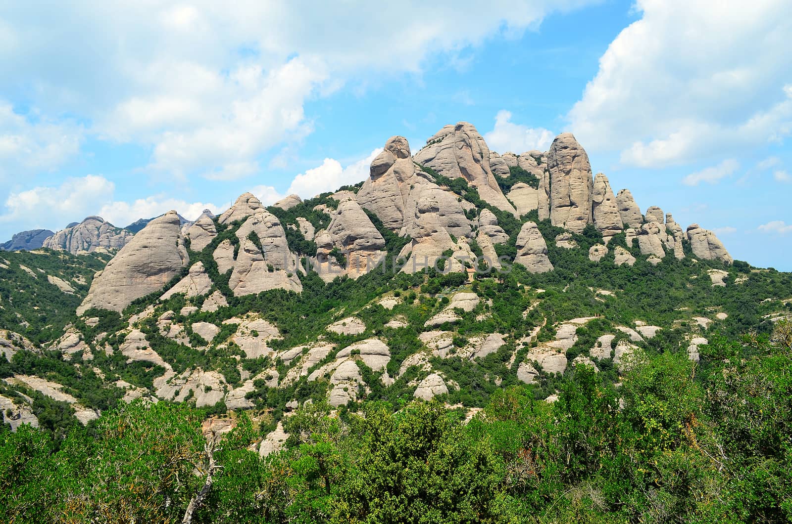 Montserrat is a multi-peaked mountain located near the city of Barcelona, in Catalonia.  "Montserrat" literally means "saw mountain" in Catalan.
