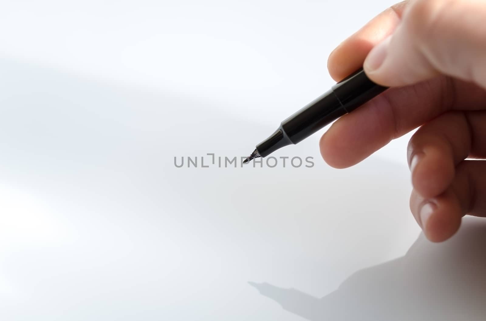 Pen in the hand isolated over white background