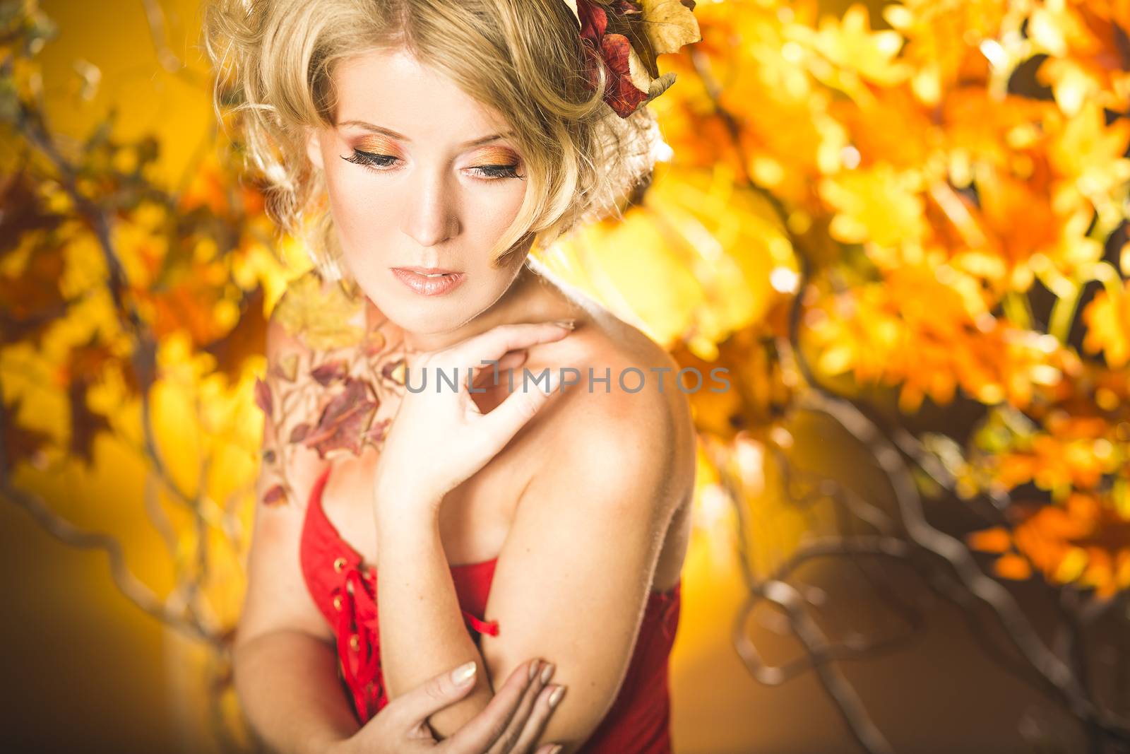 Fragile woman in autumn sun golden floral tree background