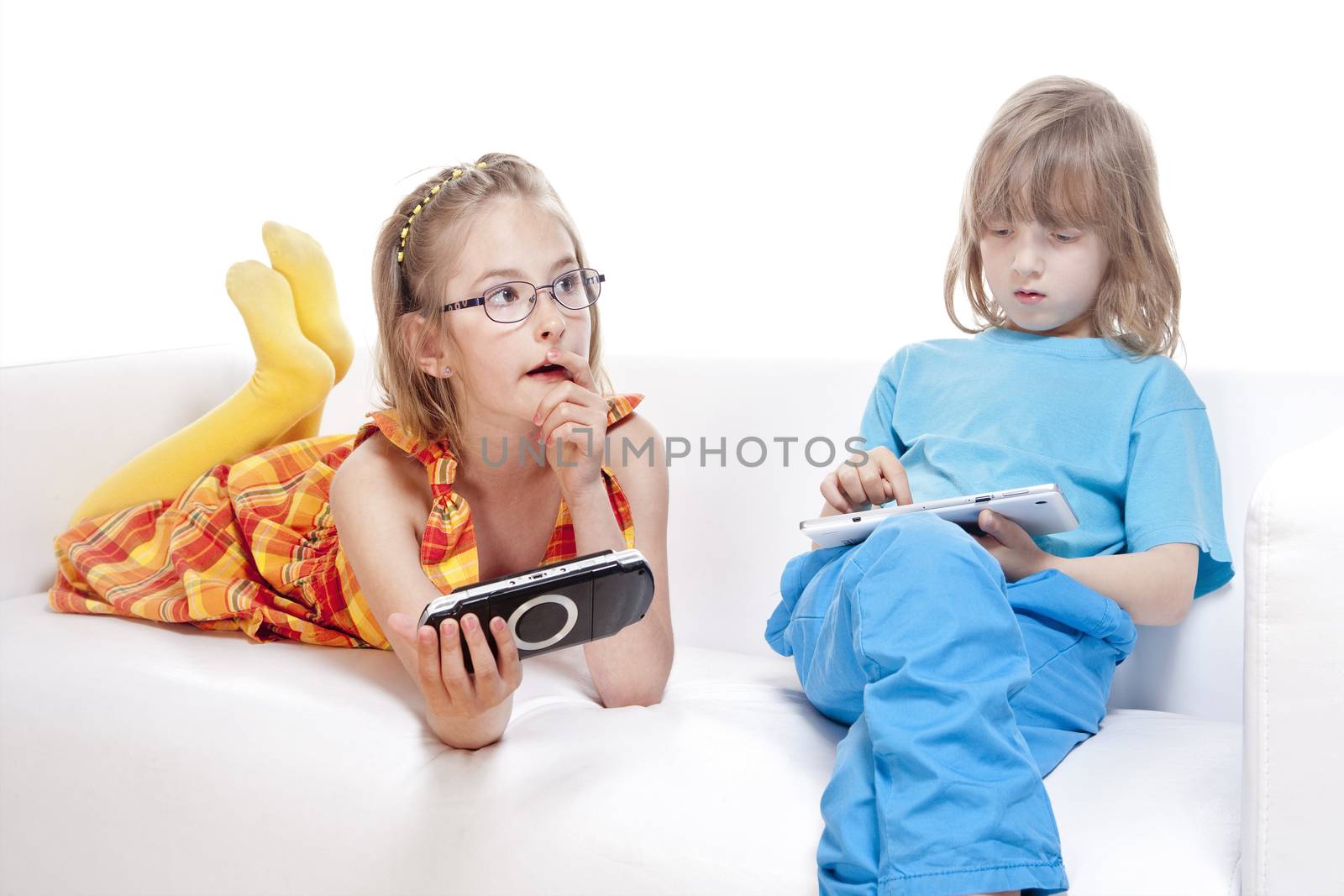 Two Children Having Fun with Digital Gadgets - Isolated on White