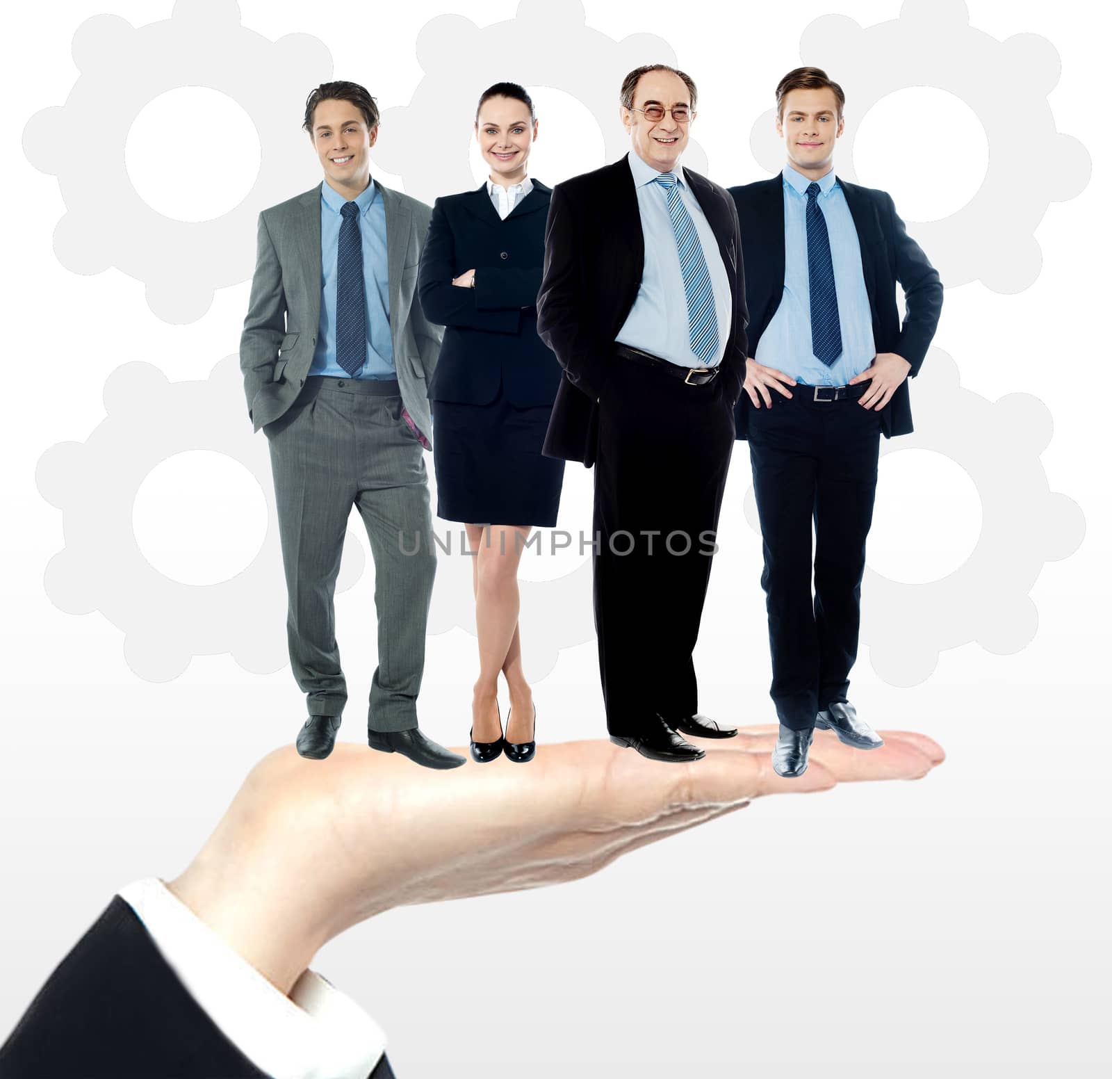 Group of business people standing on palm by stockyimages