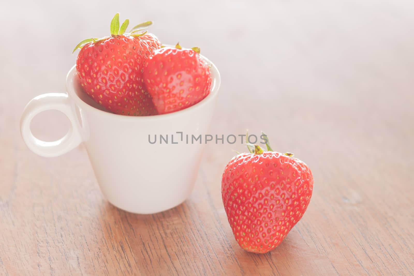Fresh strawberries on wooden table, stock photo