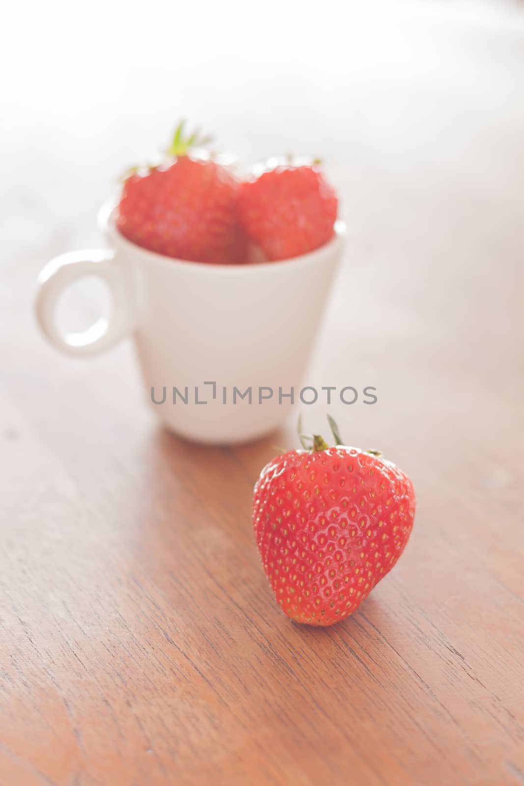 Fresh strawberries on wooden table, stock photo