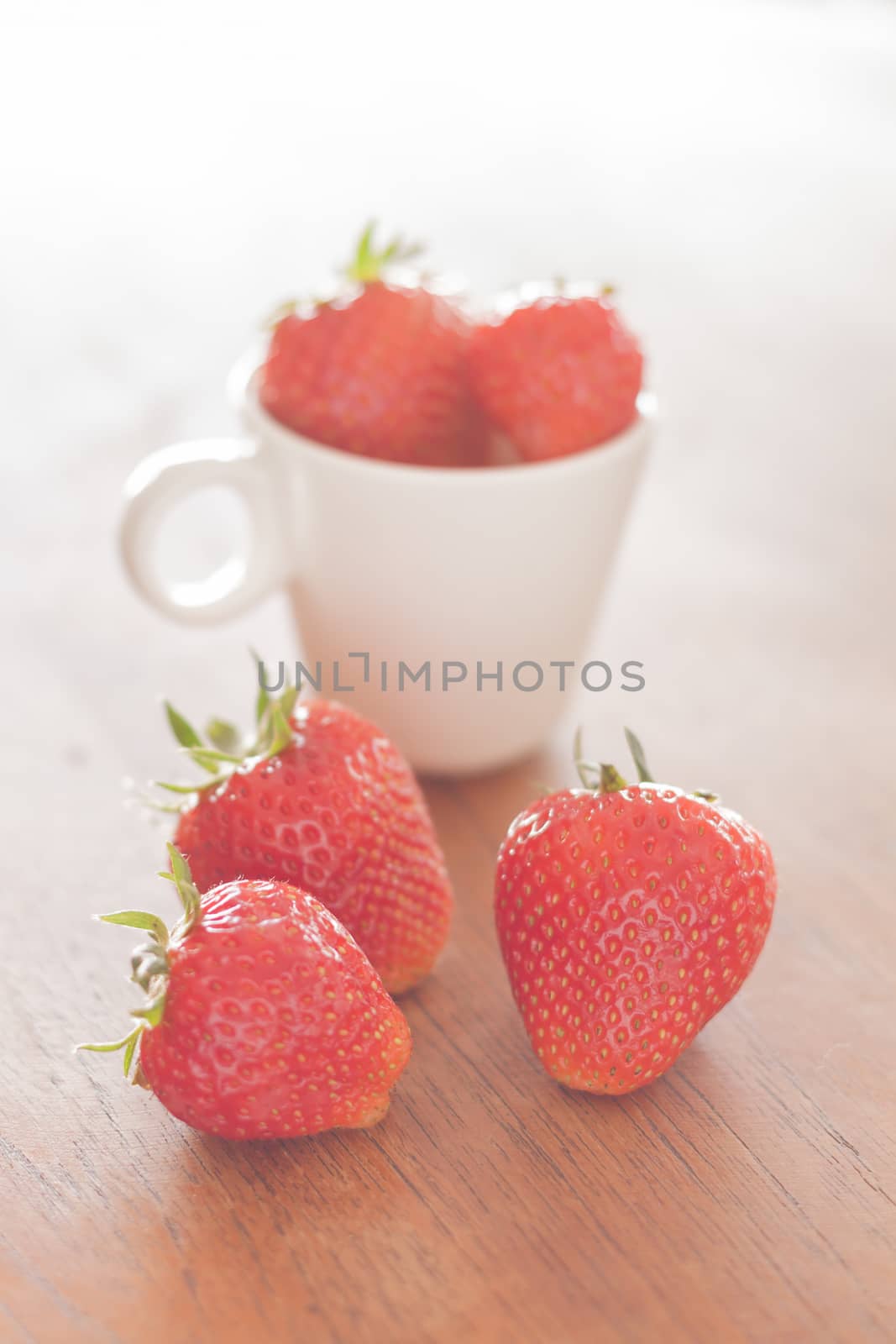 Fresh strawberries on wooden table, stock photo