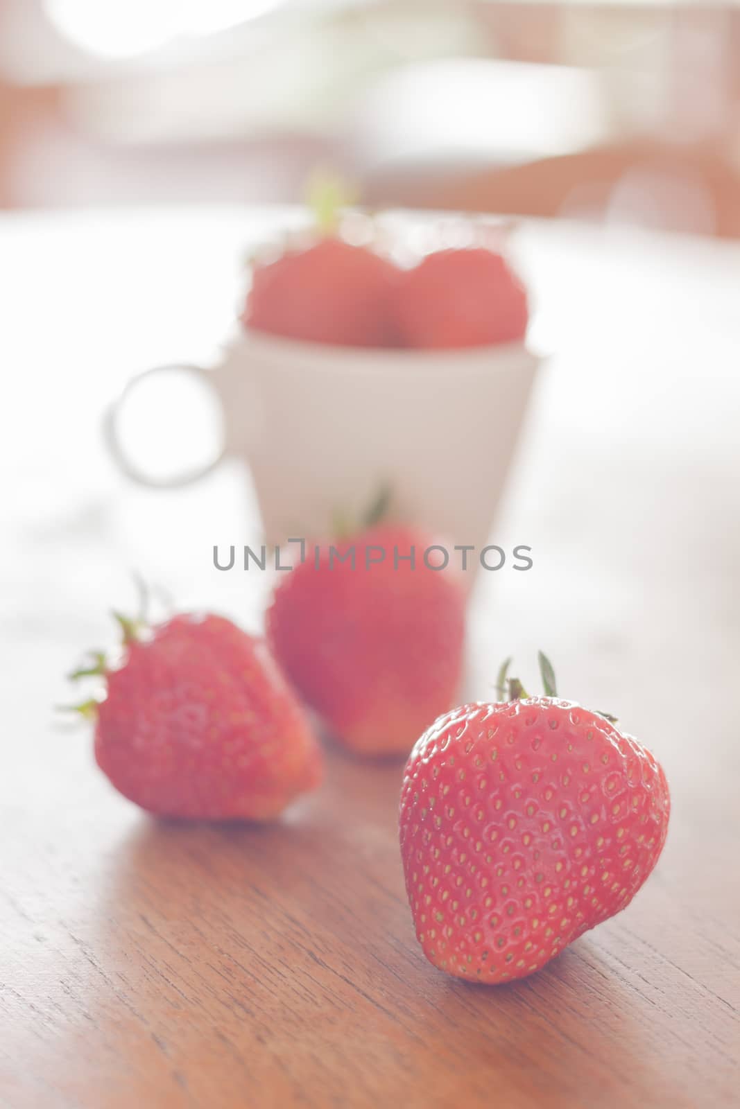 Fresh strawberries on wooden table, stock photo