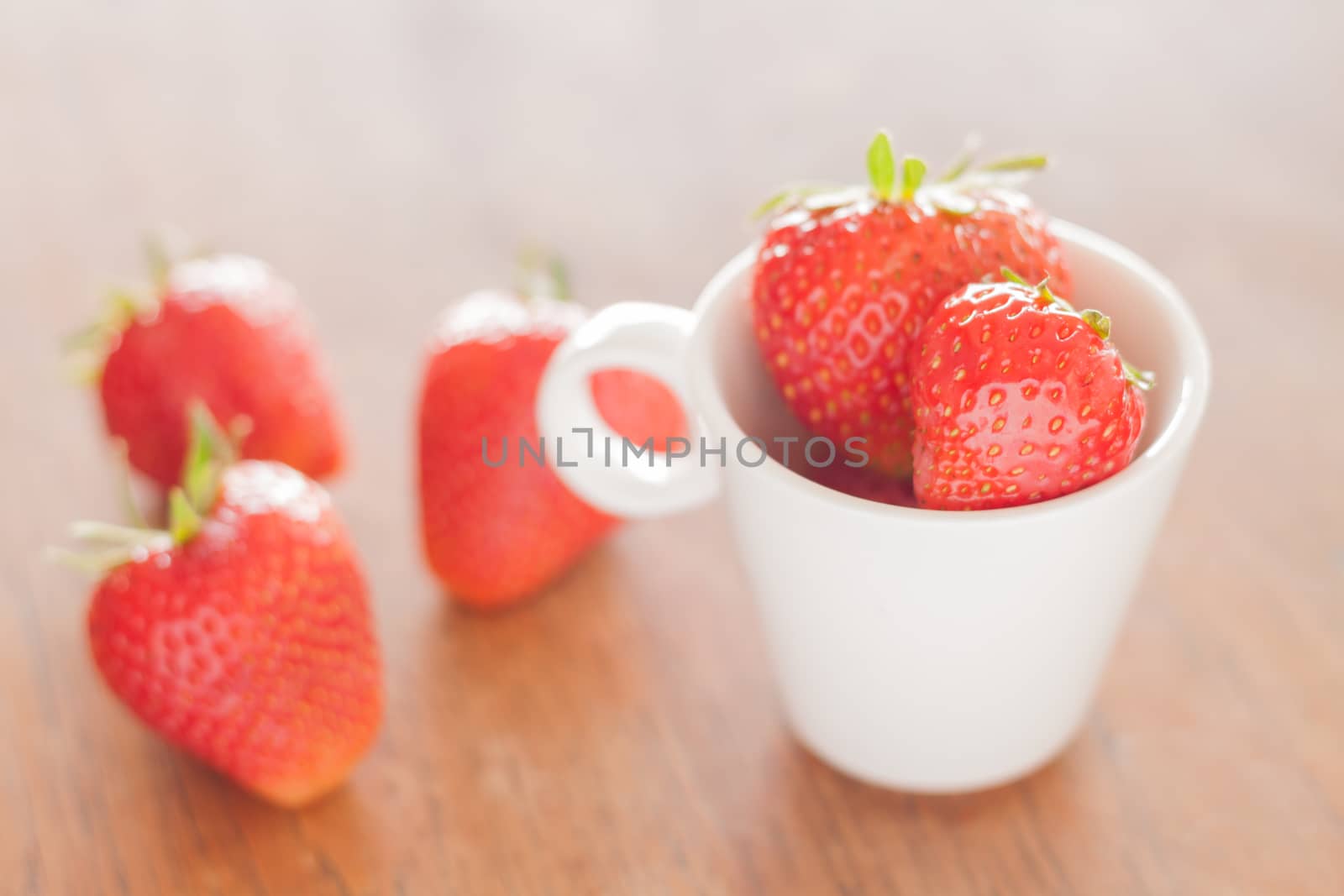 Fresh strawberries on wooden table, stock photo